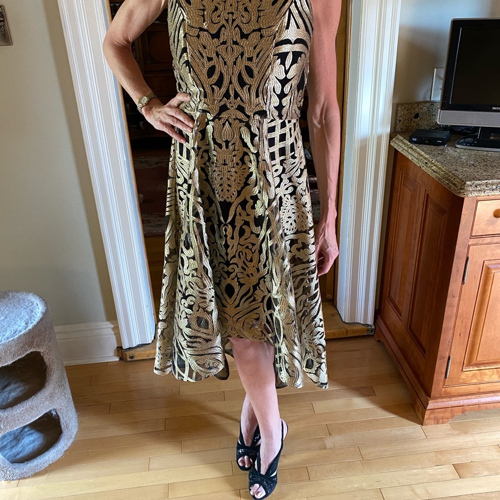 Brand new without tags Frank Lyman size 8 High low dress gold pattern throughout